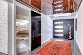 An original jim sherrill mahogany sculpture was restored and set in front of the property, alluding to the home's interior style. Two Story Mid Century Home Gets Fancy Remodel