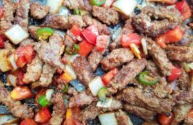 Beef Strips Sauteing In A Skillet With Onions Serrano Peppers Garlic And Tomatoes For Bistec A La Mexicana Recipe Bistec Recipe Stuffed Peppers Recipes