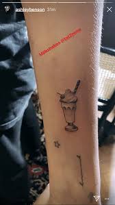 The one on his right bicep appears to be a wave. Ashley Benson Debuted A Tiny Milkshake Tattoo