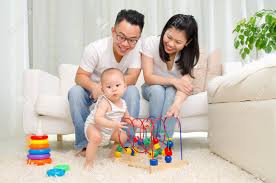 Pick your baby's toys at a designated time of the day to avoid toys piling up your living room. Asian Parent Looking At Their Baby Playing Toy In The Living Stock Photo Picture And Royalty Free Image Image 71173089