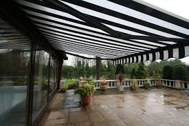 Black And White Striped Retractable Awning Awning On A Pool Cabin Outdoor Awnings Retractable Awning Patio
