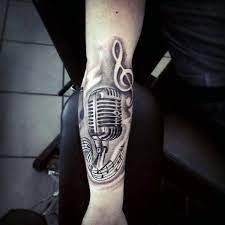 This guitar tattoo will present you as a peaceful person who loves to nurture music. 90 Microphone Tattoo Designs For Men Manly Vocal Ink Microphone Tattoo Music Tattoo Designs Tattoo Designs Men