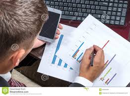 Businessman With Phone Studying Charts Stock Image Image