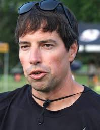 Cross country runners dash under the lights at Ford Field in Livonia