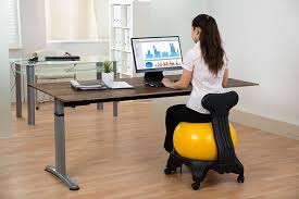Sit on the ball with your back straight and your feet hip width apart, a few inches away from the ball. Simple Exercises For Office Workers