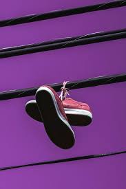 Sneakers on the telephone wire. Sneakers Hanging Over Power Line Photograph By Hanjo Hellmann