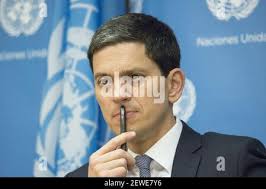 NEW YORK (April 23, 2016) Cmdr. Alex Hampton, an F/A 18 Hornet strike  fighter pilot assigned to U.S. Northern Command and native of Chicago,  Illinois, sharing a laugh with students from Edward