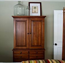 Though on the traditional side, this armoire is hardly short on glamour. Decorate The Top Of An Armoire Armoire Decorating Armoire Tv Cabinet Decor