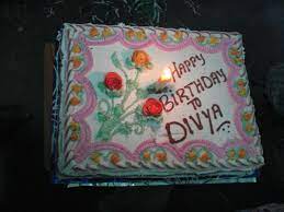 Tasty birthday cupcake with candle on table against blurred lights, space for text. Birthday Cake On Divya First Birthday Divyashree Lakshmi