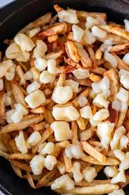 Poutine, made with french fries, gravy, and cheese curds, is a canadian classic. Canadian Poutine Whipped It Up