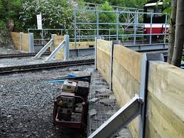Retaining walls are strong walls that retain soil and divert water. Railway Sleepers Slotted Into Rsjs Or Steel H Or I Beams