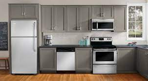 Gray is the new white (or black in some cases) and we love seeing it in kitchen design. Kitchen Awesome White Grey Themes Of Kitchen Appliance Package Set On Brown Laminate Floor R White Kitchen Appliances Kitchen Design Laminate Kitchen Cabinets
