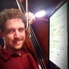 How do cellists hear themselves in an orchestra setting?