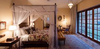 Farmhouse canopy bed + nightstand. Best Tea Plantation Stay In Sri Lanka Luxury Bungalow Accommodation