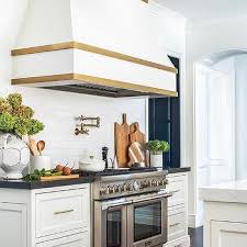Custom architectural sheet metal fabrication. White And Gold Range Hood Design Ideas