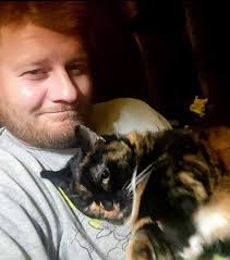 Breakthrough! After one year of Gideon's re-homing and not being a cuddle  or lap cat whatsoever, he finally snuggled up to his owner (my daughter) as  she laid