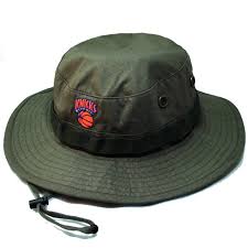 Original fit adjustable wool blend hat by mitchell & ness that has deep crown and flat brim, light heather grey crown with royal blue visor and matching button, dark green undervisor, embroidered team logo on front in team colors, metal eyelets, mitchell & ness embroidered over back opening. Newyork Knicks Mitchell Ness Team Olive Green Boonie Bucket Booton
