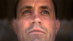 Did officers ram prisoner's head into window, or did he crack it himself?