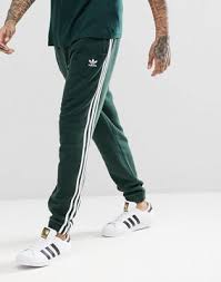 Adidas Originals Three Stripe Cuffed Sweatpants In Black Adidas Originals Adicolor 3 Stripe Joggers In Green Cx1898 Mens Street Style Street Style Outfits Men Striped Sweatpants