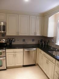 Kitchen Imposing Glossy Black Countertop To Combine With Cream Cabinet And Brown Tiled Traditional Small Kitchens Small Kitchen Cabinets Brown Tile Backsplash