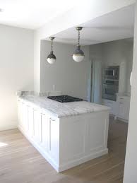 Kitchen Island Cooktop Contemporary Kitchen Benjamin Moore Glacier White White Gold Design White Kitchen Cabinets Gorgeous Kitchens White Kitchen