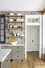 Speaking of cool, it's lovely how the cool tones on the countertop pick up on the greys in the brick. Traditional Farmhouse Style Home Koby Kepert