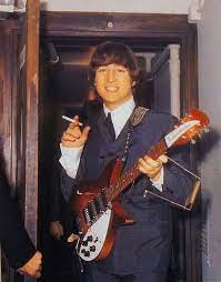 Lennon's hand is square and actually wider than the length of his fingers. John With His Rickenbacker 325 Rose Morris Fireglo Guitar The Beatlebacker Photographed Backstage Another Be Beatles Guitar John Lennon Beatles John Lennon
