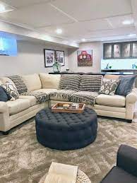 A Hgtv Fixer Upper Inspired Basement Remodel With Cozy Neutral Furniture And Bright Painted Interior Basement Living Rooms Basement Design Family Room Design