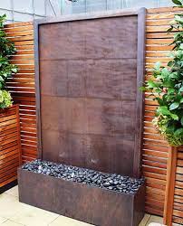 Water flows from the top to the second level where it splits into three streams and flows down into the lower level and down to the basin in five streams. Garden Water Walls Wall Water Features David Harber