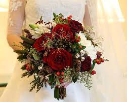 Red flowers add drama and romance to your fall wedding bouquet. Winter Wedding Bouquet Ideas Red Rose Greenery White Small Mini Pinecones Winter Wedding Bouquet Christmas Wedding Flowers Flower Centerpieces Wedding