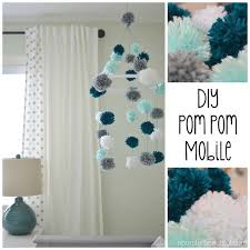 A Diy Pom Pom Mobile Made From Yarn And An Embroidery Hoop Is A Fun And Stimulating Addition To Your Little O Baby Nursery Diy Diy Baby Stuff Diy Nursery Decor