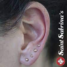 Four Earlobe Piercings With Yellow Gold Ball Ends Done By Courtney Jane Maxwell At Saint Sabrina S In Minneapolis Mn Ear Piercings Piercings Piercing