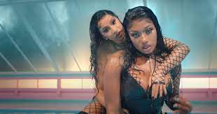 Portrait of aged woman resting in bedroom with grownup son and watching tv in evening together. Watch Cardi B And Megan Thee Stallion Music Video For Wap