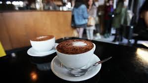 Coffee cafe shop restaurant cup drink cafeteria brown coffee brown shop. Video Footage With Tight And Shallow Focus On A Cup Of Cappuccino In A London Coffee Shop Scene With Customers Lining Up By The Background Counter