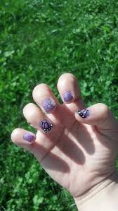 Purple and black nails with butterfly accent. 90 Butterfly Nail Styles That Will Set Your Heart Fluttering