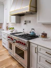Buying a new stove hoods could be your chance to improve the design of your kitchen space. Stainless Steel And Brass Kitchen Hood With Wolf Dual Range Transitional Kitchen