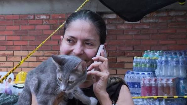 Vickye Giraldo, una abogada de 56 años cuyo edificio fue destruido por el  terremoto en Cali, saluda felizmente a Polux, uno de sus gatos domésticos  rescatado de los escombros. Video: AFP 📲