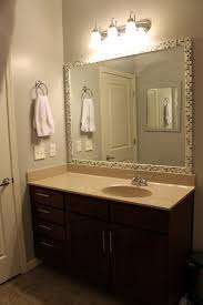 I had intended to hang the empty frame over my bathroom mirror (so mirror would extend beyond the frame), but was surprised and pleased when it turned out to be a standard bathroom mirror size and we could mount the mirror right inside it. How To Frame A Mirror With Tile