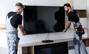 Professional technician mounting TV on wall