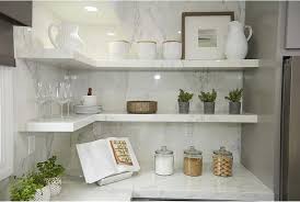 White Quartz Floating Shelves Are Stacked In An L Shape In The Corner Of A Kitchen Featuring A M Floating Shelves Floating Shelves Kitchen Floating Shelf Decor