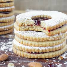 Roll balls into slivered almonds, if desired. Traditional Raspberry Linzer Cookies Christmas Cookies