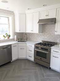 By adding grey subway tiles to your kitchen backsplash, you will be able to spruce your kitchen up and make your kitchen look like an inviting one. Gray White Kitchen With Subway Tile Backsplash In Fireclay Tile
