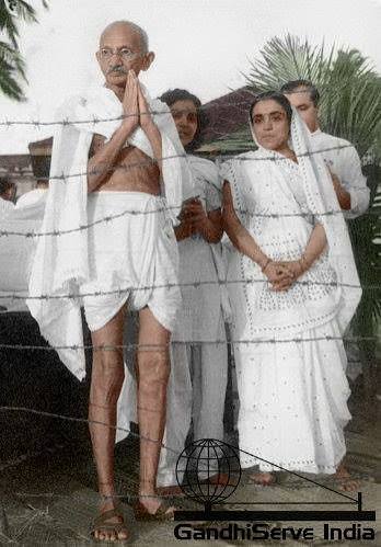 MAHATMA - Mahatma Gandhi standing behind a barb wire and greeting people at "Palm Bun", Juhu Beach, Bombay, May/June 1944.Next to Gandhi from left: Dr. Sushila Nayar, his hostess, Sumati Morarjee and
