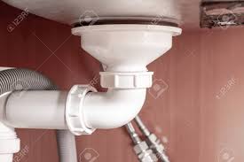 A kitchen sink faucet leaking underneath your cabinets or a dripping drain pipe is certainly annoying but being able to spot the leak early helps prevent serious damage. Hydraulic Siphon Pipes And Water Drain Under The Kitchen Sink Stock Photo Picture And Royalty Free Image Image 122898377