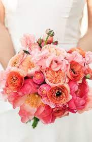 A coral color palette can also be big and bold when you include colors like bright orange and yellow, and add small pops of contrasting color for excitement and depth. Romantic Elegant Coral Coral Wedding Flowers Flower Bouquet Wedding Coral Bouquet Wedding