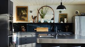 This light and bright kitchen features white wood cabinets paired with charcoal soapstone countertops and a light gray tile backsplash. In This Kitchen Renovation The Cabinetry Used To Be In An Nyc Apartment Architectural Digest