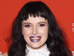 Bella thorne departed from her signature red locks for a new photoshoot, in which she rocked bright blonde hair and a versace swimsuit. Bella Thorne Debuts Black Hair With Bangs
