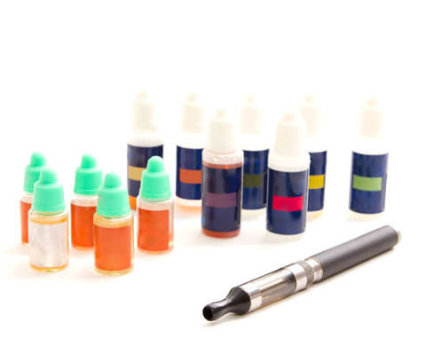 Refillable vape pen and collection of e-juice bottles featured on VapeFeat
