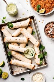 These baked chicken taquitos are stuffed with seasoned shredded chicken, cream cheese, diced green chiles, black beans and corn. Baked Chicken Taquitos