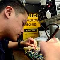 Aviation Ordnanceman Airman Austin Otto performs maintenance